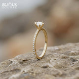 Brilliant Round-Cut Diamond Engagement Ring with Sparkling Side Stones on a Classic Gold Band - Bijoux Eclore