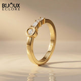 Sculptural Solid Gold Ring Showcasing a Radiant Round Centerpiece and a Parallel Duo of Precision-Cut Baguette Diamonds - Bijoux Eclore
