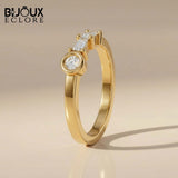 Sculptural Solid Gold Ring Showcasing a Radiant Round Centerpiece and a Parallel Duo of Precision-Cut Baguette Diamonds - Bijoux Eclore