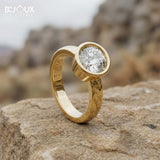 Round-Cut Diamond Surrounded by a Polished Gold Bezel on a Simple, Elegant Band - Bijoux Eclore