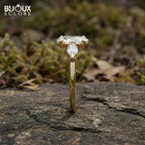 Oval-Cut Center Diamond with Sparkling Trilliant Side Stones Set in a Luxurious Yellow Gold Band - Bijoux Eclore