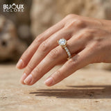 Round-Cut Diamond Set in a Timeless Yellow Gold Band with Glimmering Accent Diamonds - Bijoux Eclore
