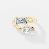 Stunning Dual-Diamond Ring Featuring Emerald and Pear Cut Stones in a Graceful Bypass Design - Bijoux Eclore