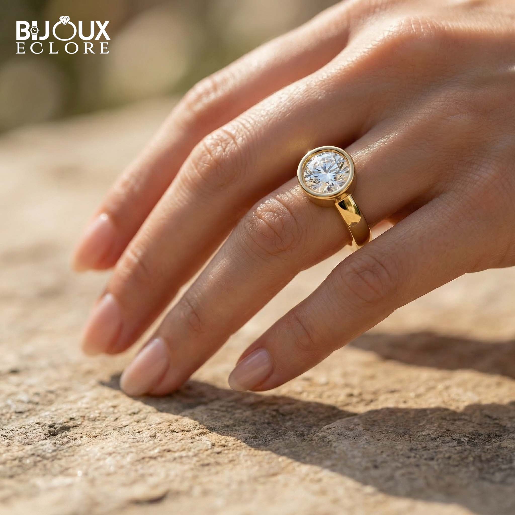 Round-Cut Diamond Surrounded by a Polished Gold Bezel on a Simple, Elegant Band - Bijoux Eclore