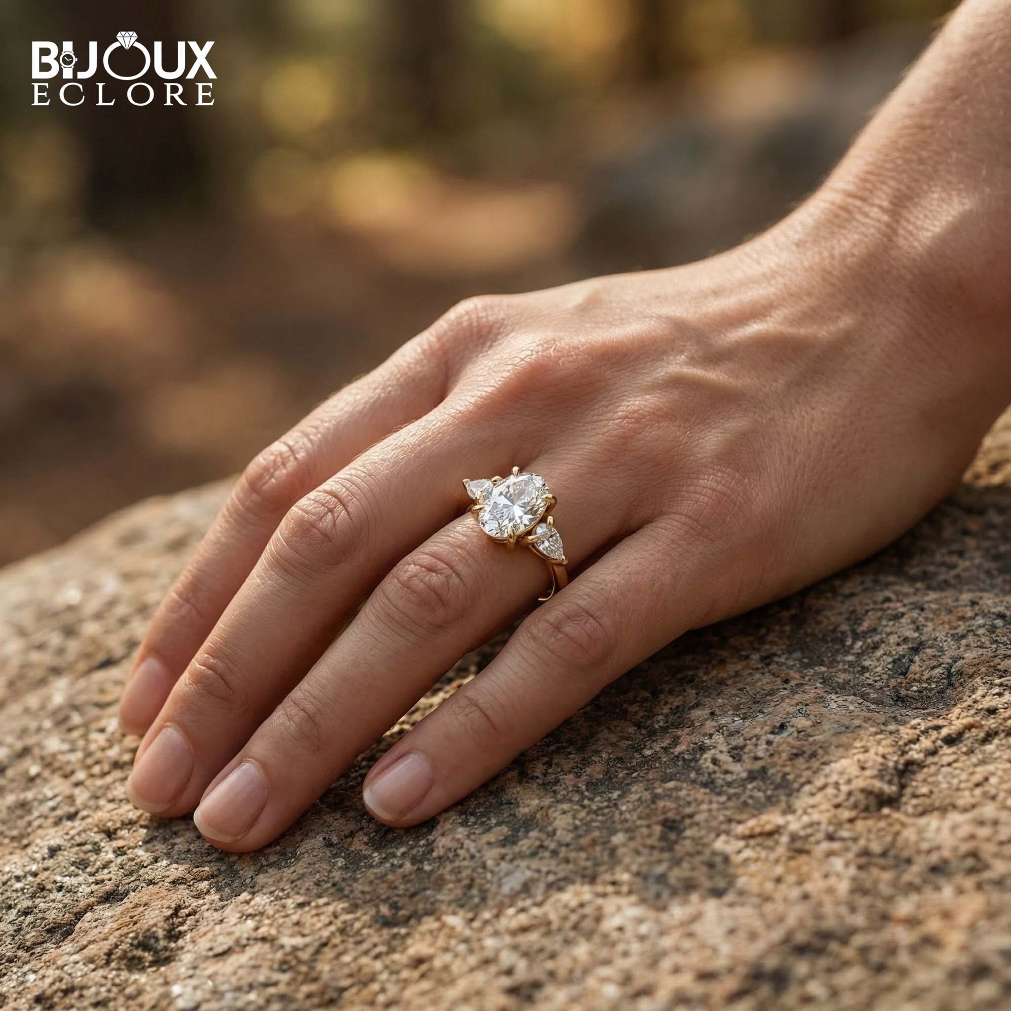 Oval-Cut Center Diamond with Sparkling Trilliant Side Stones Set in a Luxurious Yellow Gold Band - Bijoux Eclore