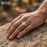 Oval-Cut Center Diamond with Sparkling Trilliant Side Stones Set in a Luxurious Yellow Gold Band - Bijoux Eclore