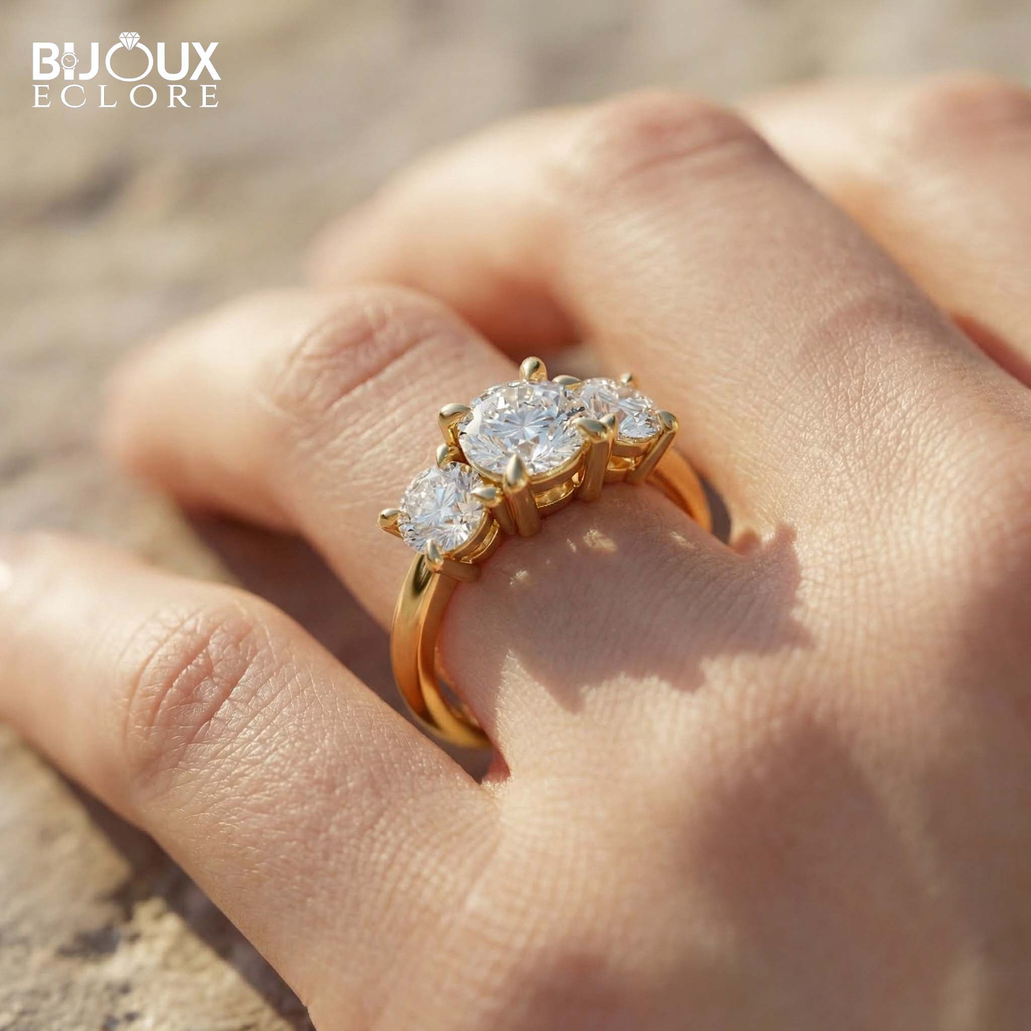 Oval-Cut Center Diamond with Flanking Round Accent Stones Set in a Timeless Yellow Gold Band - Bijoux Eclore
