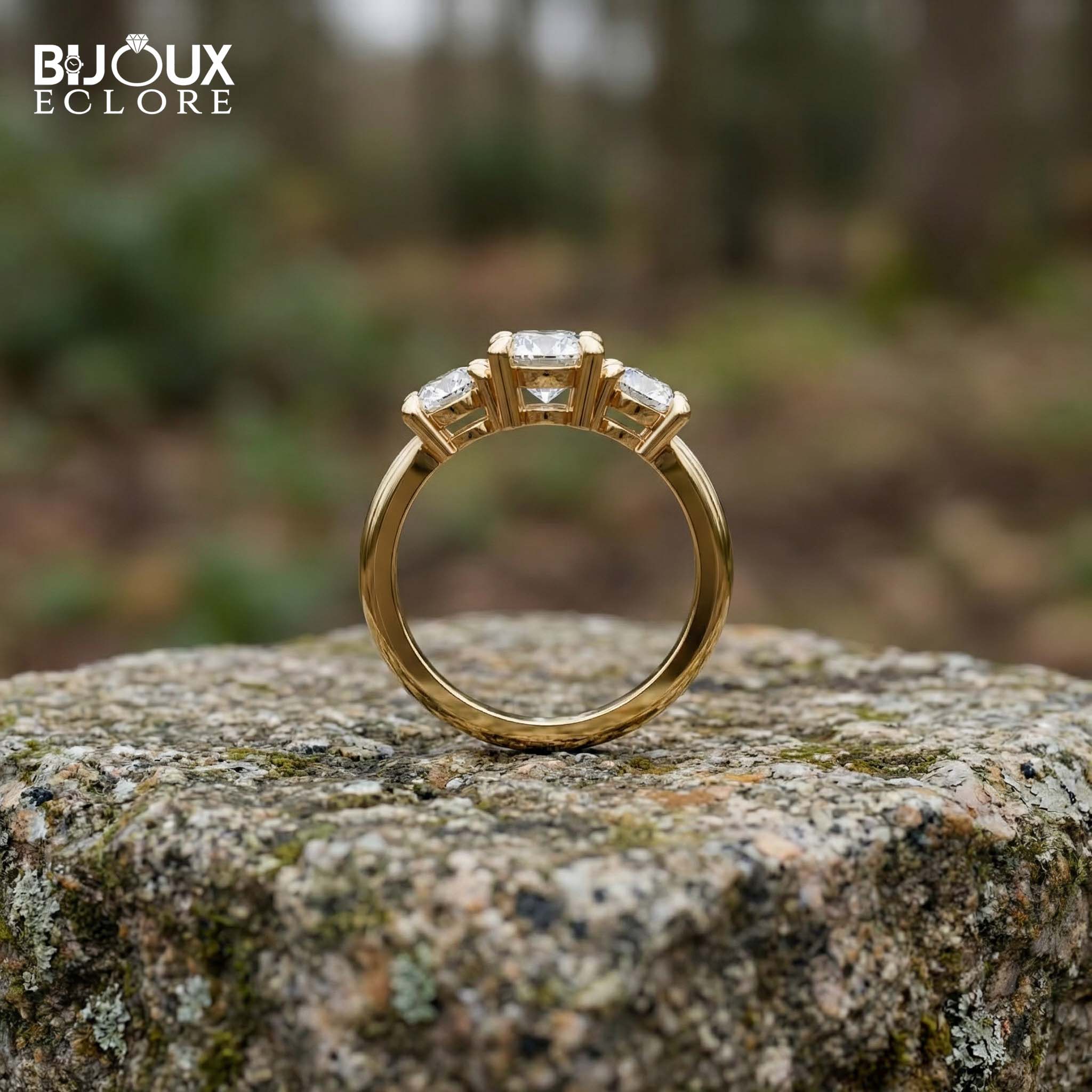 Oval-Cut Center Diamond with Flanking Round Accent Stones Set in a Timeless Yellow Gold Band - Bijoux Eclore