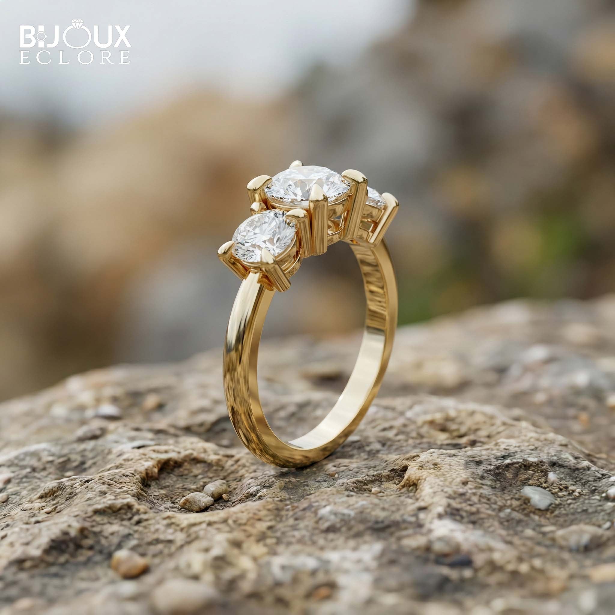 Oval-Cut Center Diamond with Flanking Round Accent Stones Set in a Timeless Yellow Gold Band - Bijoux Eclore