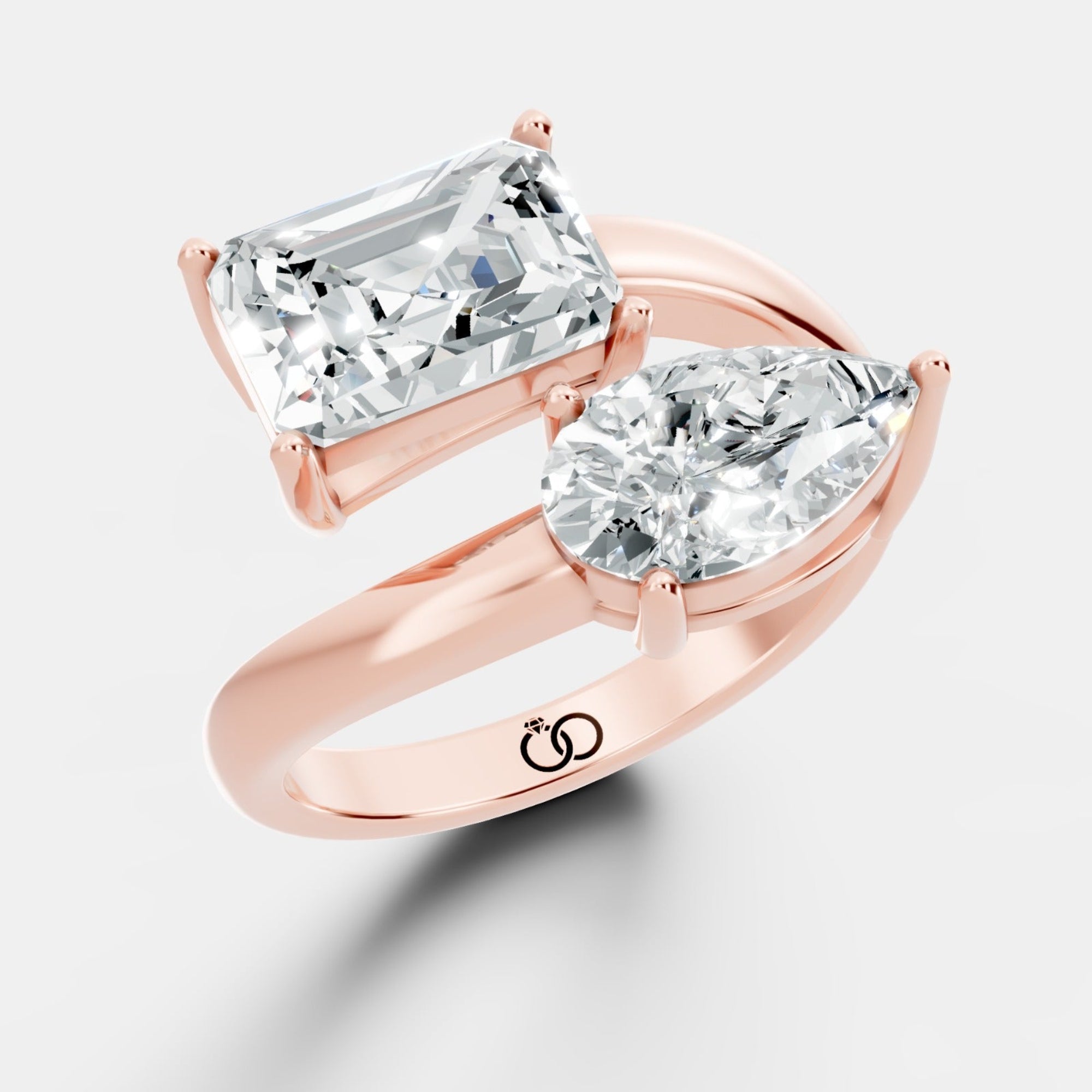 Stunning Dual-Diamond Ring Featuring Emerald and Pear Cut Stones in a Graceful Bypass Design - Bijoux Eclore