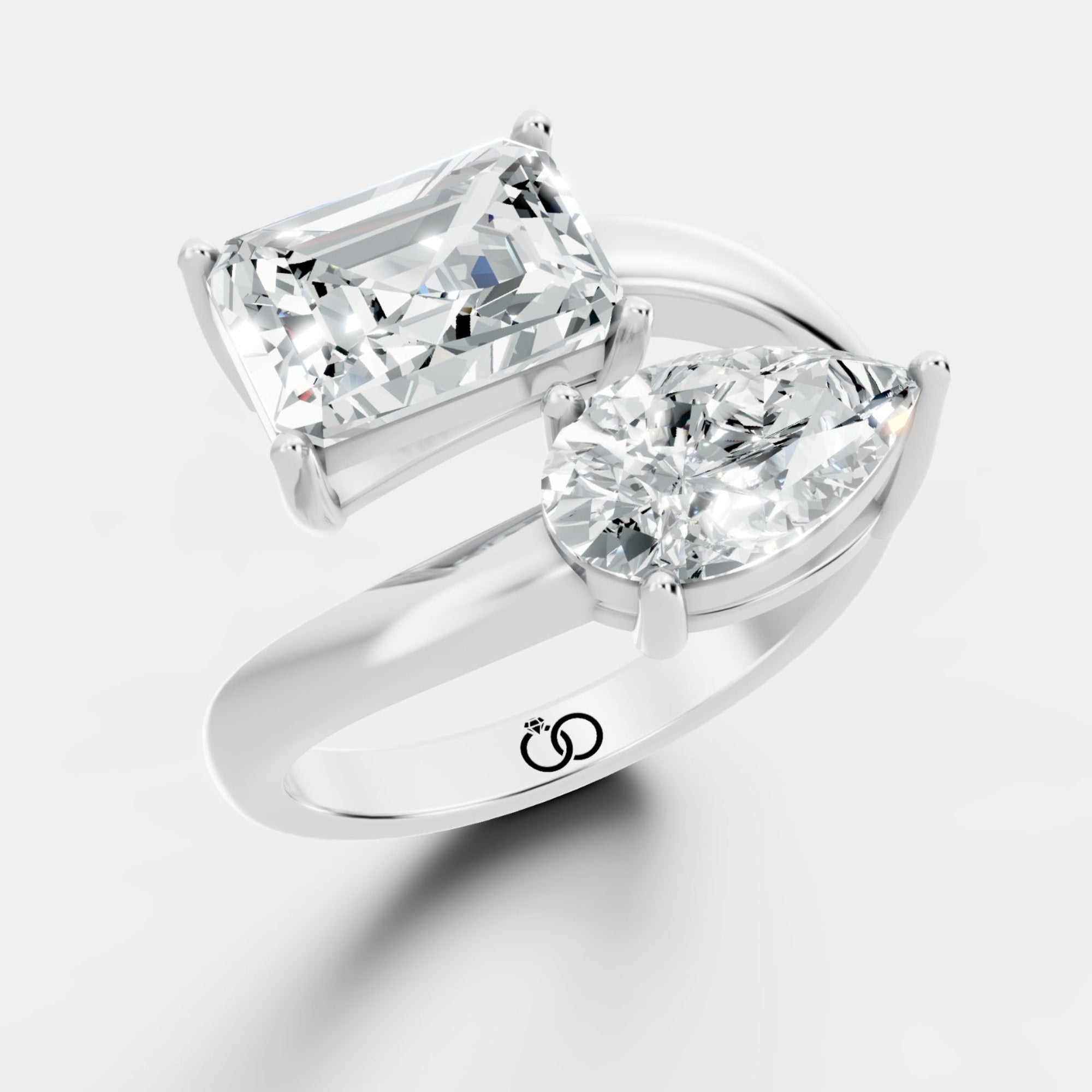 Stunning Dual-Diamond Ring Featuring Emerald and Pear Cut Stones in a Graceful Bypass Design - Bijoux Eclore