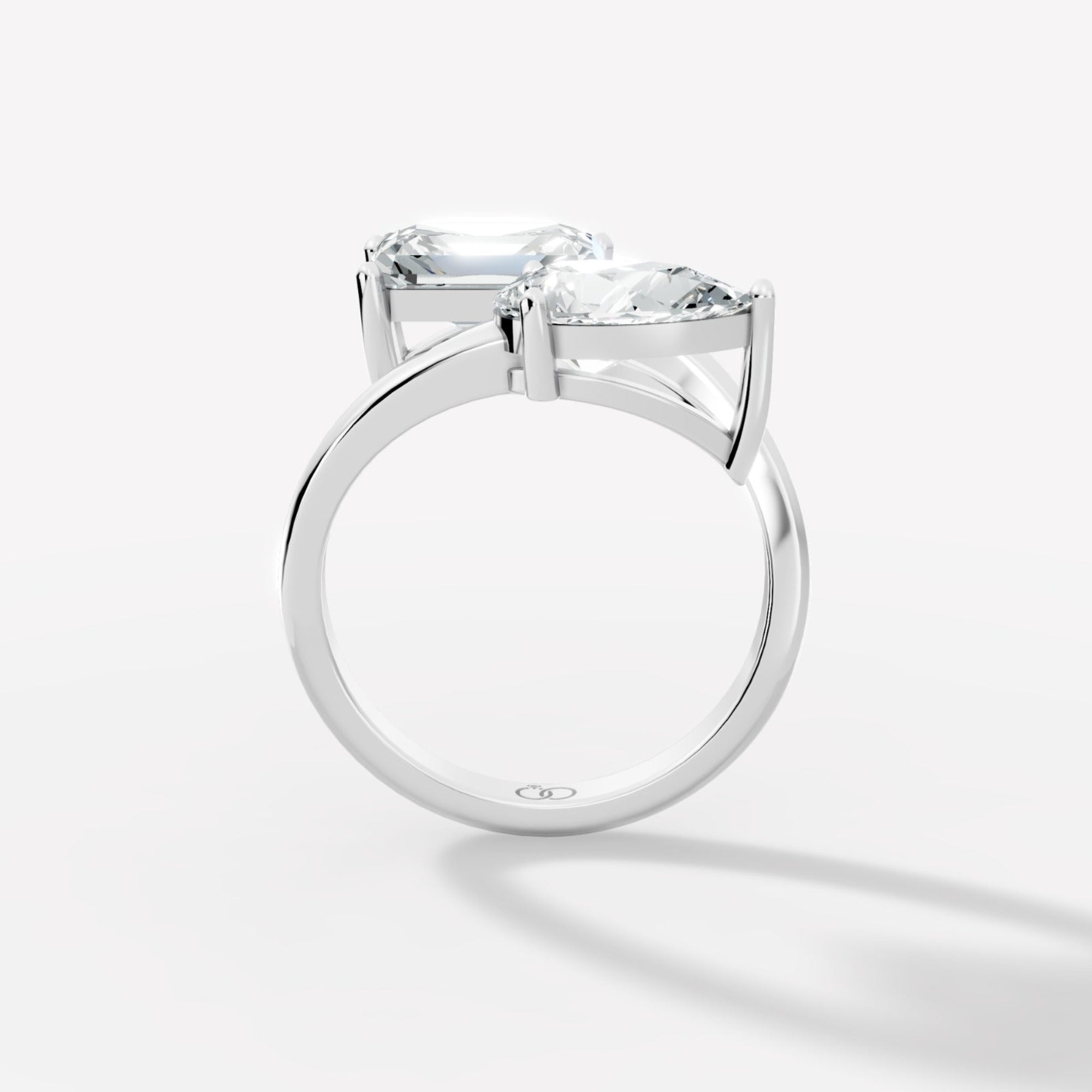 Stunning Dual-Diamond Ring Featuring Emerald and Pear Cut Stones in a Graceful Bypass Design - Bijoux Eclore